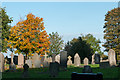 Gravestones with autumnal trees