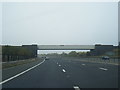 M65 eastbound passes under railway bridge