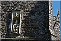 Plymtree: St. John the Baptist church: Weathered sculpture of the Virgin and Child