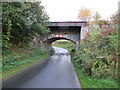 Road (B6405) and former railway bridge at Hassendean