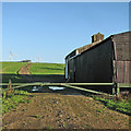 TL5751 : Rectory Farm: barns and turbines by John Sutton