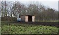 Wooden shelter in field