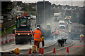 Laying down the final surface to the alterations on the A3125 at Bridge Wharf