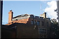 View of the rear of a house on Tite Street from a gap between the houses on Embankment Gardens