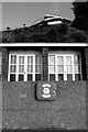 Beach huts below a modern apartment block