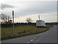 Wide grass verge at the junction of Henver Lane and B3285