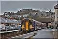 NM8529 : A Class 156 diesel train at Oban train station with McCaigs Tower in the background by Garry Cornes