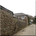 Stone wall alongside the road at Polteggan Farm