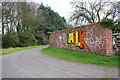 Brick wall at junction of footpaths