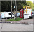 Red phonebox between two white vans, Lower Lydbrook