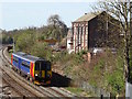 An East Midlands train passing the former brick and terracotta works