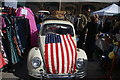 View of a Volkswagen Beetle adorned with the Stars and Stripes in the Classic Car Boot Sale in Kings Cross