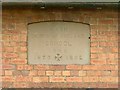 Commemorative plaque in the wall of the old school, Nash