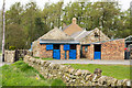 Stables at Blue Gables with cat on wall