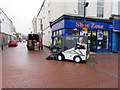 Street cleaning vehicle on a Neath corner