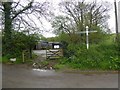 Farm and signpost at Watergate Cross