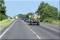TF5119 : Tractor Heading East along the A17 near to Walpole Cross Keys by David Dixon