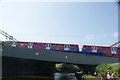 View of a DLR train crossing the River Lea from the River Lea towpath