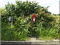 TM0449 : Tollemache Hall Postbox & Roadsign by Geographer