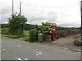 NY0634 : Postbox and phone box in Harker Marsh by Graham Robson