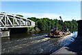 Crane ship passes open swing bridge, Warrington