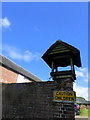 A bell tower on a brick wall at Whitehill House