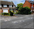 White marked potholes on Rowanfield Road, Cheltenham