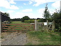 TM0173 : Field entrance & footpath to Walsham Road & The Grundle Byway by Geographer
