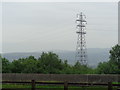 Power lines with hills behind