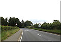 TM0890 : Entering New Buckenham on the B1113 Castle Hill Road by Geographer