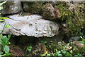 Benchmark on stone in wall beside minor road near Crackpot