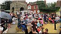 People sitting around the clocktower in Bildeston.