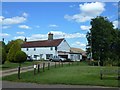 TF6403 : Village green and cottage in Crimplesham, Norfolk by Richard Humphrey