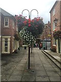 SJ6552 : Nantwich: hanging baskets in Cocoa Yard by Jonathan Hutchins