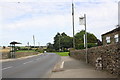 Milepost and bus stops beside the A6108