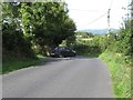 J1315 : Car emerging on to the Corrakit Road from a minor road leading from the Clermont Pass Bridge by Eric Jones