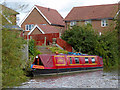 Moored narrowboat by new housing near Nuneaton, Warwickshire