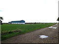 TM0893 : Farm Building at Old Buckenham Airfield by Geographer