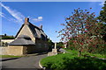 The village cross and Buttercross Cottage, Barrow