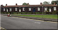 Row of single-storey wooden houses, Farm Road, Street, Somerset