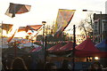 TQ2481 : View of flags against the setting sun from the Portobello Road Winter Festival #3 by Robert Lamb
