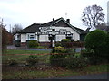 Old road sign and bungalow on Crewe Road (A534), Willaston