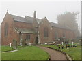 All Saints Church in Baschurch with its tower under repair on a misty December morning