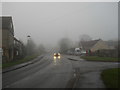 TF1505 : High Street, Glinton, on a foggy day by Paul Bryan