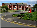 Queen Elizabeth II postbox and a dragon tail bench on a Tywyn corner