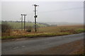 SP3312 : Electricity power lines crossing single track road from Minster Lovell by Roger Templeman