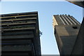 Looking up at a block of flats and one of the Barbican Towers in the Barbican Estate