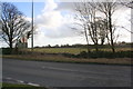 Asthall Barrow with tree from B4047 junction