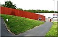 Fence, grass and paths near Tesco, Hollington