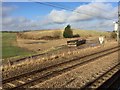 View from a Peterborough-London train - fields and abandoned skip